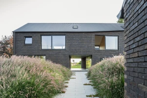 Habitat Groupé Bolette accommodates two separate houses within one confident brick volume Habitat Groupé Bolette accommodates two separate houses within one confident brick volume